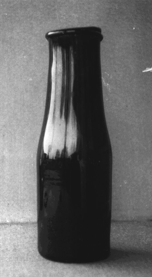 A dark glass preserving bottle with a broad neck and projecting lip