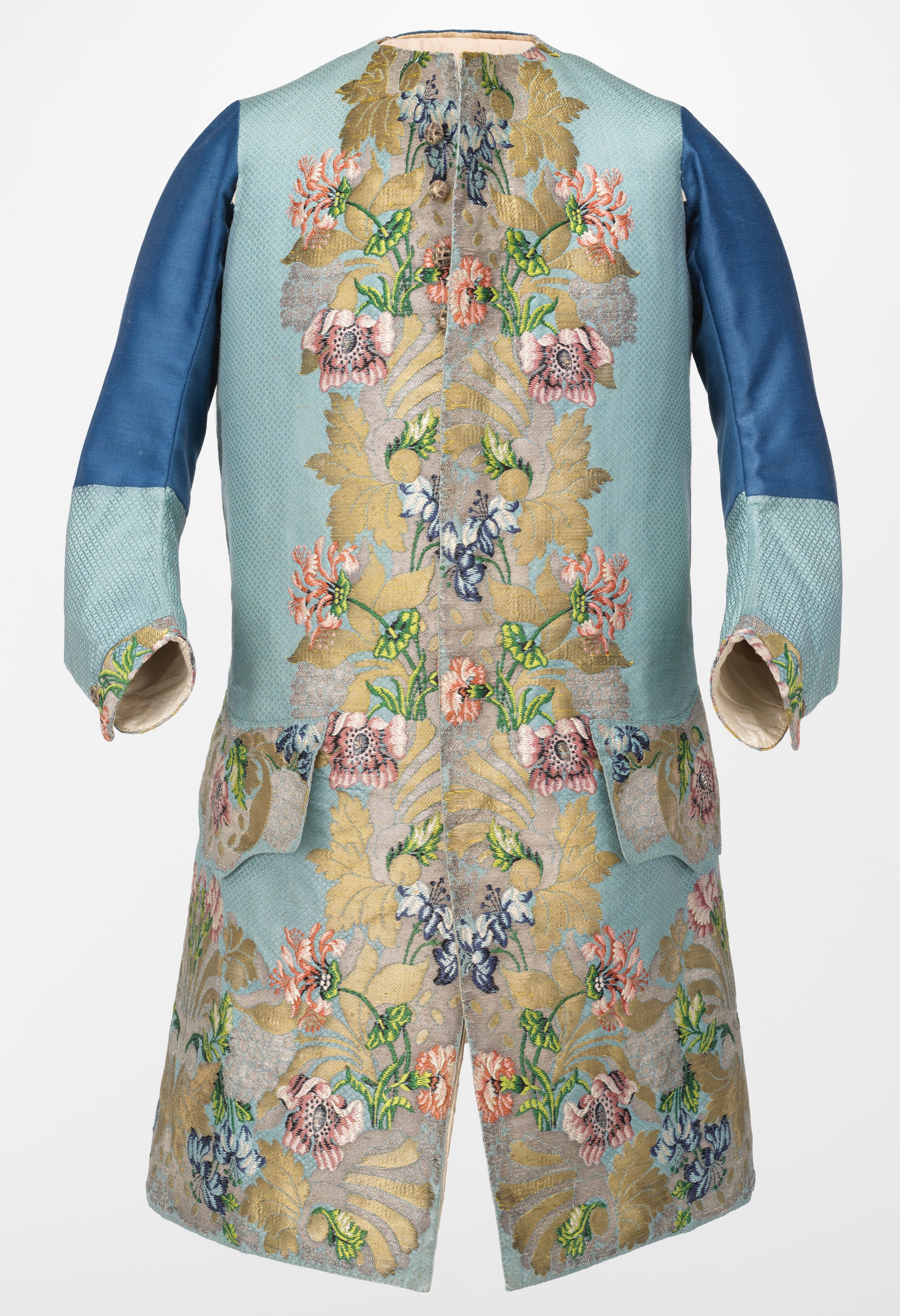 A long pale-blue sleeved waistcoat with pink and blue flowers and gold-coloured leaves woven around its opening, hem and pockets