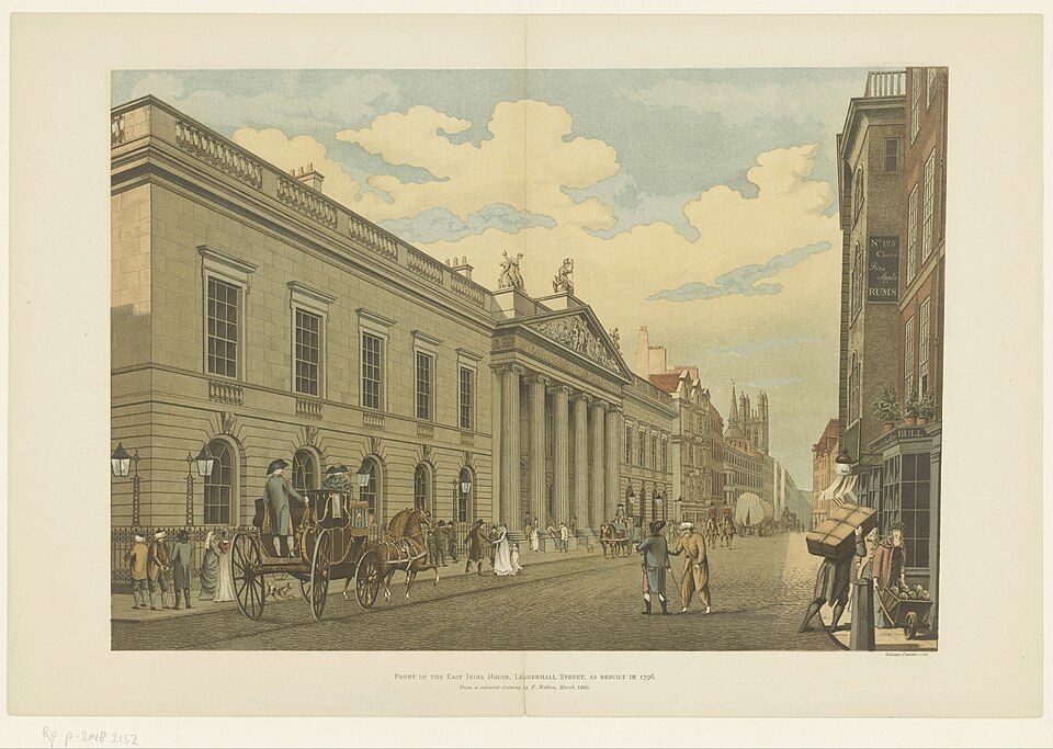 A coloured view of East India House with its columned entrance on a busy London street.