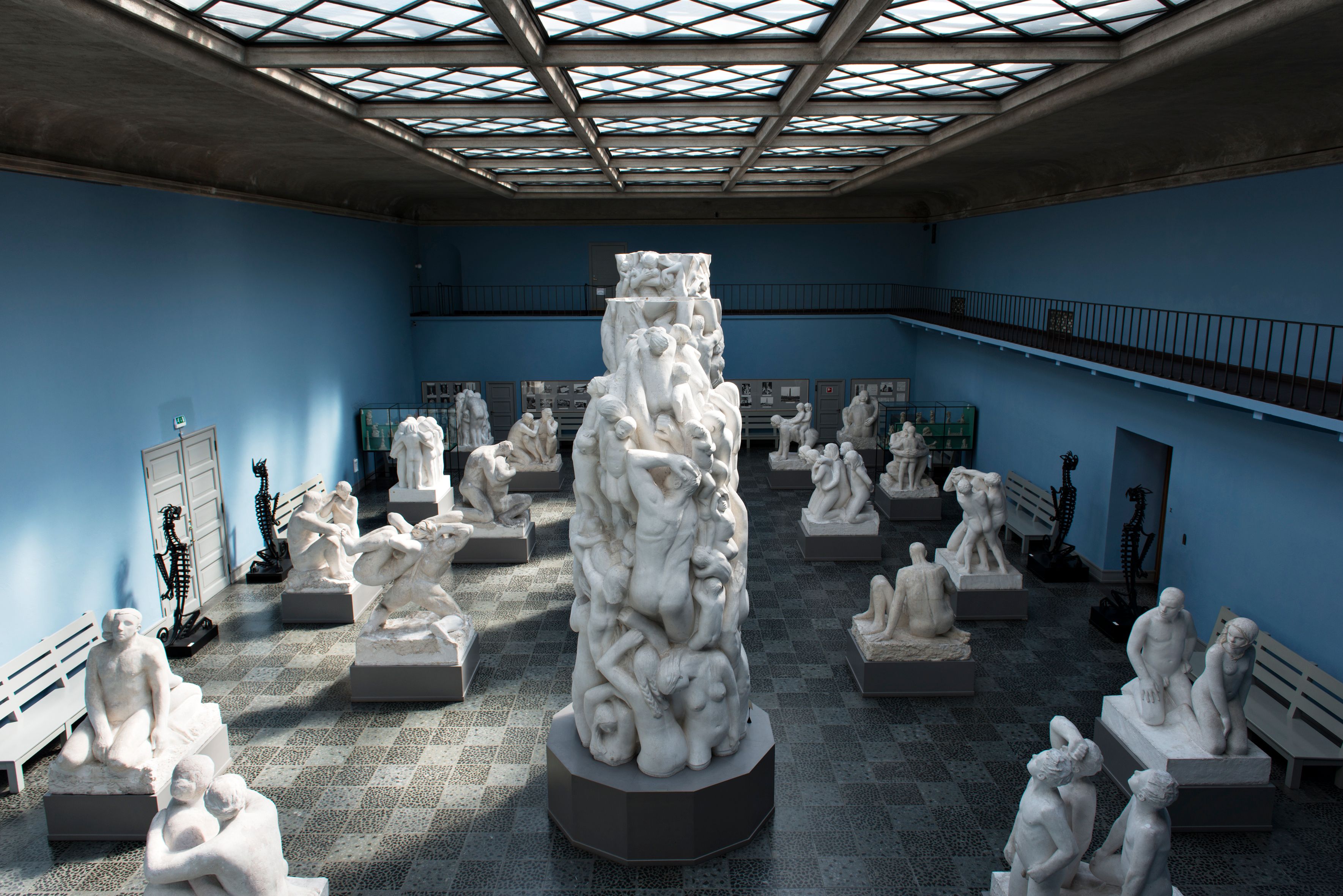 A section of the Monolith's plaster model displayed in the blue-walled Monolith Hall, surrounded by other plaster sculpture models.