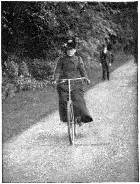 Willard riding along a path with another person farther behind