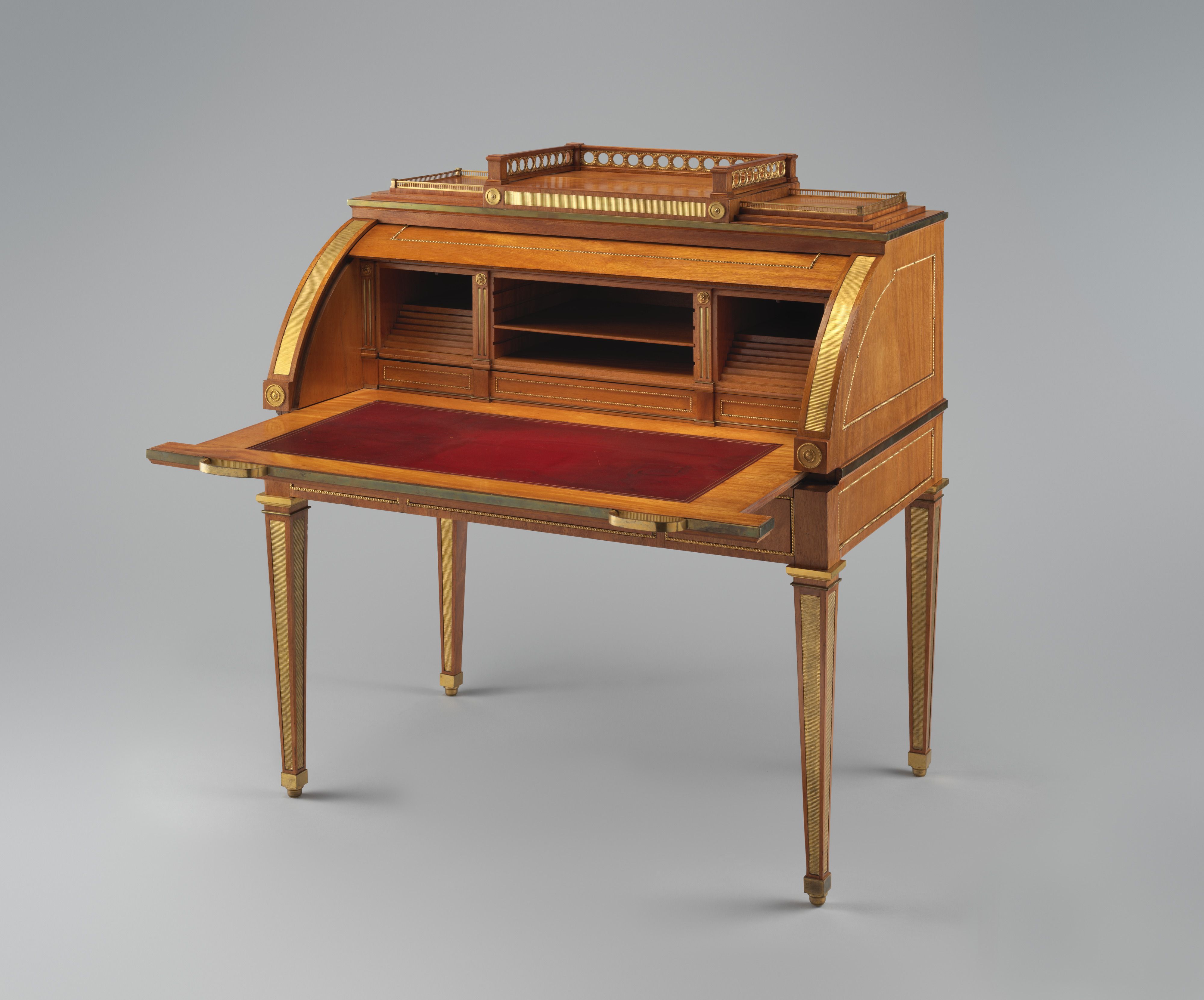 The yellowheart desk open for writing, with its leather-lined slide extended and interior compartments exposed.
