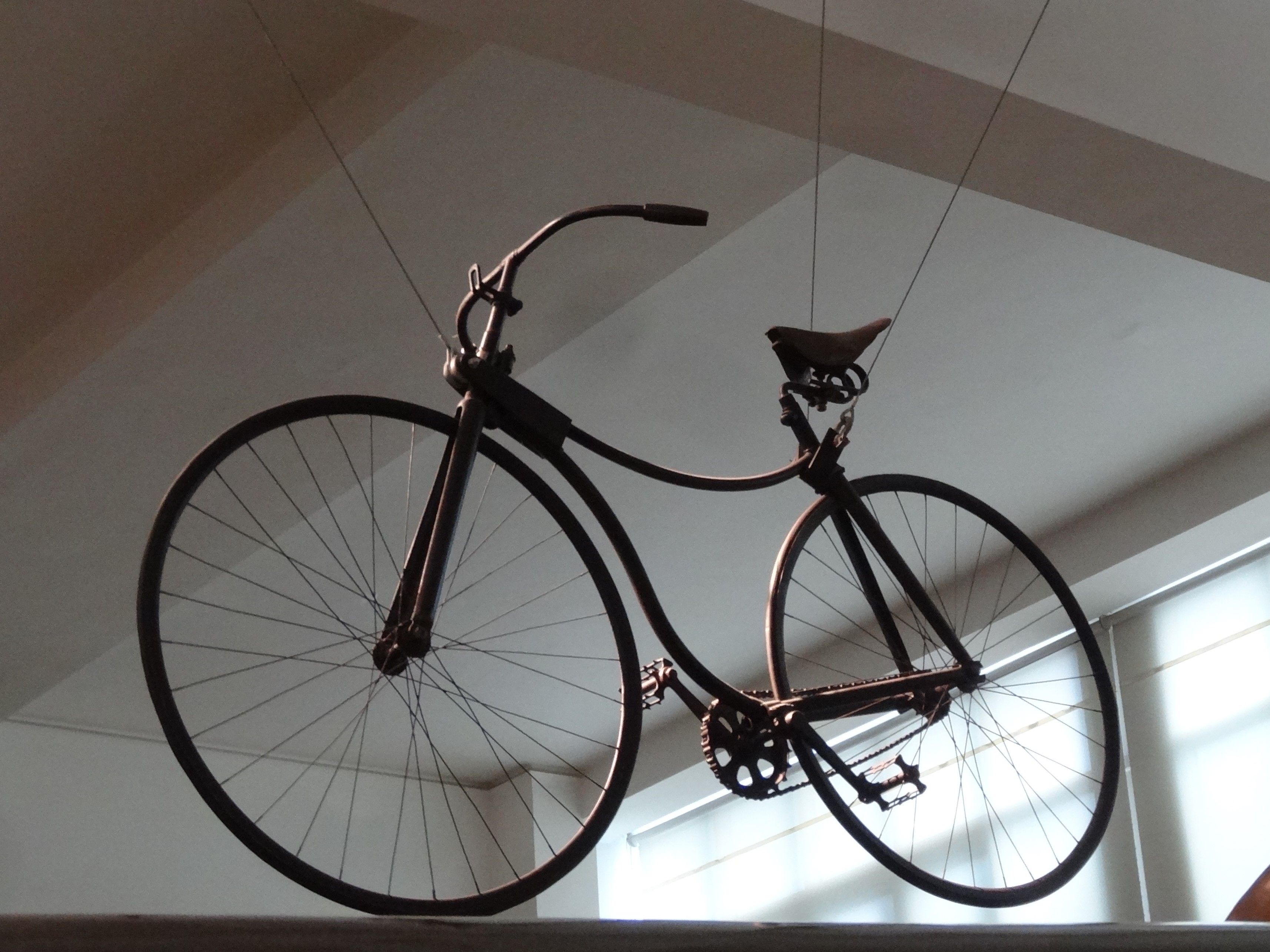 An early Rover bicycle with curved frame tubes, solid tyres and a chain driving the rear wheel