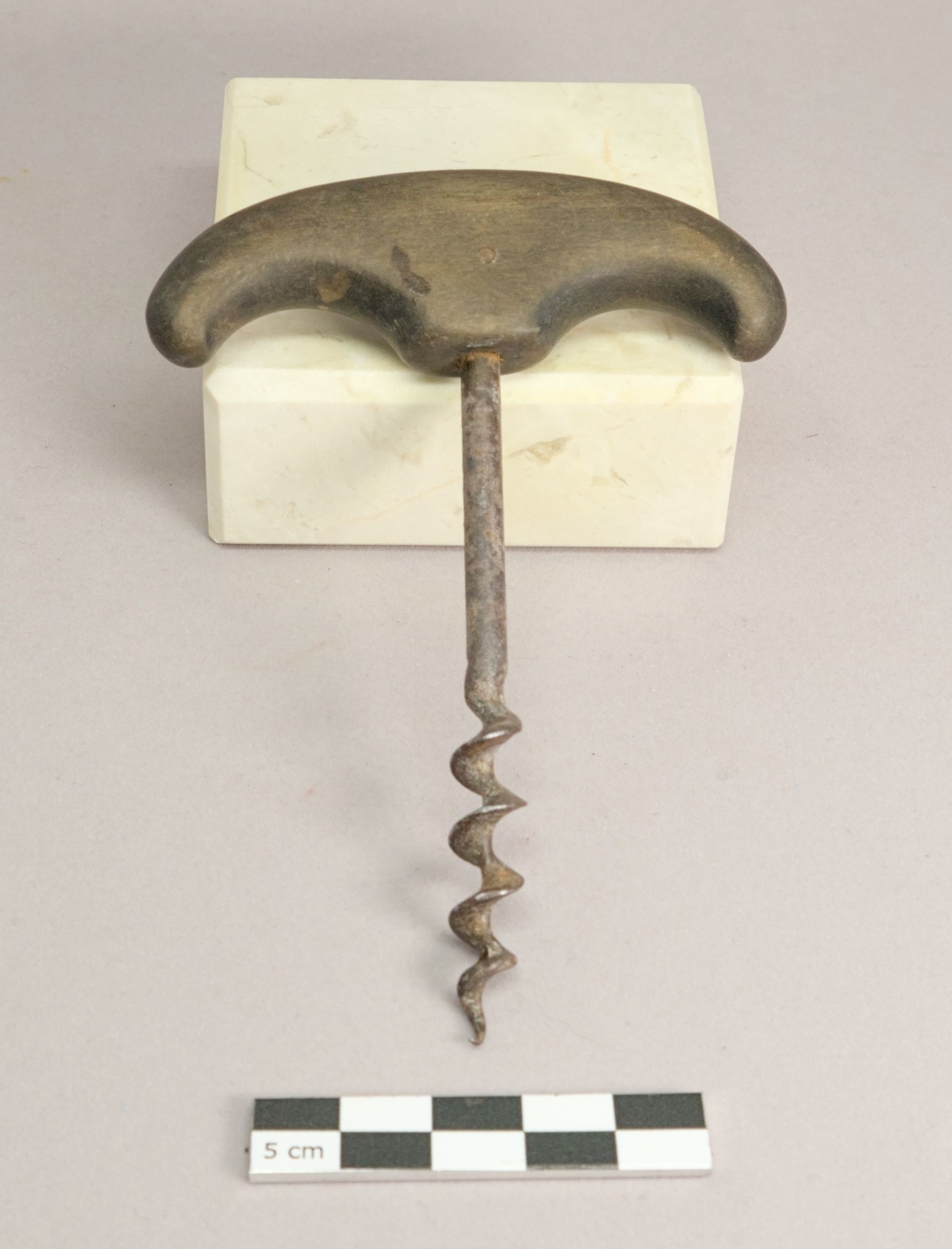 A T-shaped corkscrew with a curved handle, plain shaft and solid spiral screw