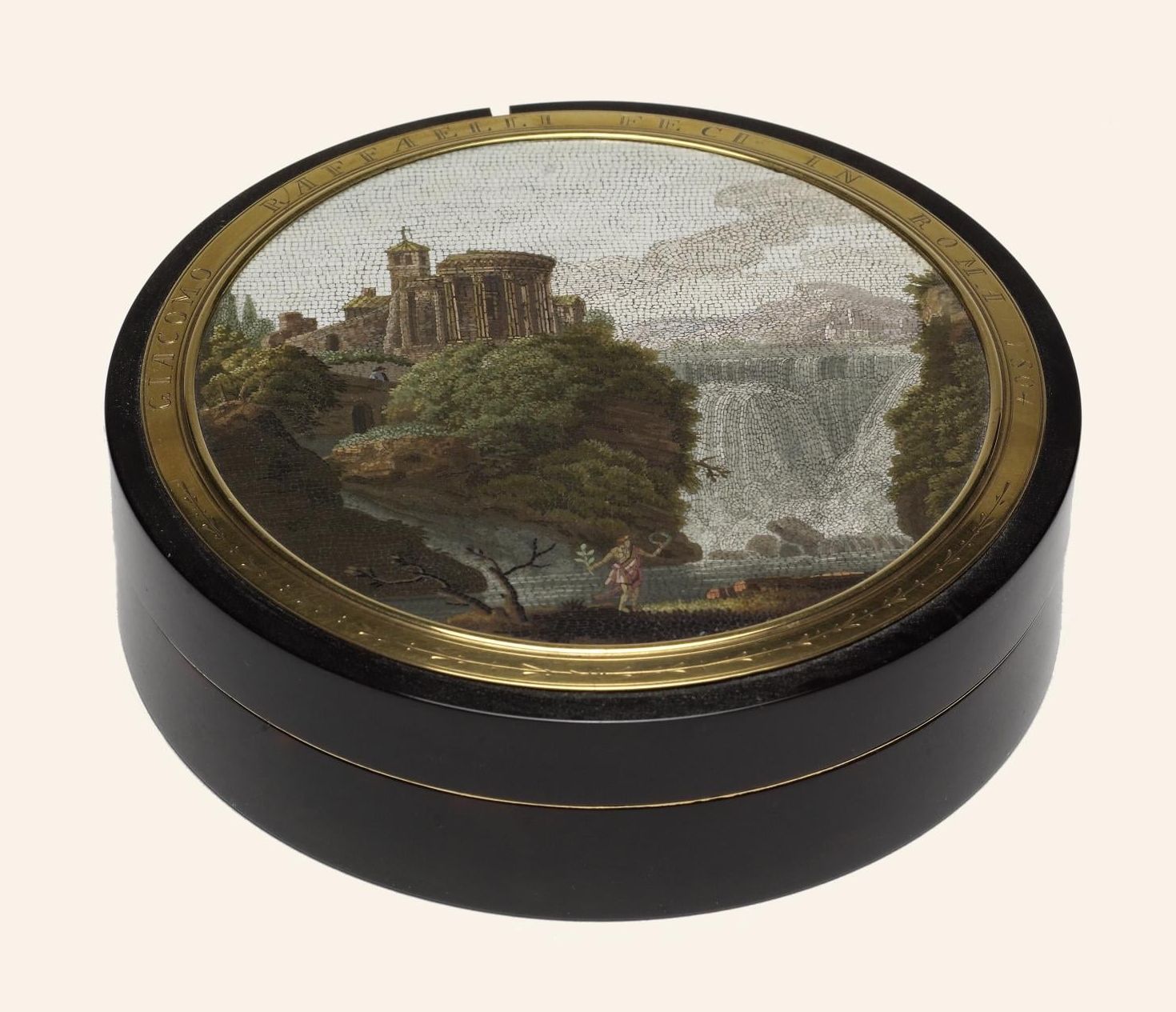 A portable glass mosaic of Tivoli in a circular box signed by Raffaelli
