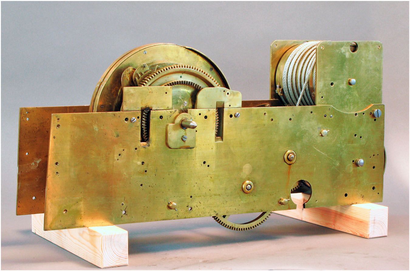 The Swan’s brass clockwork movement removed from its supporting frame.