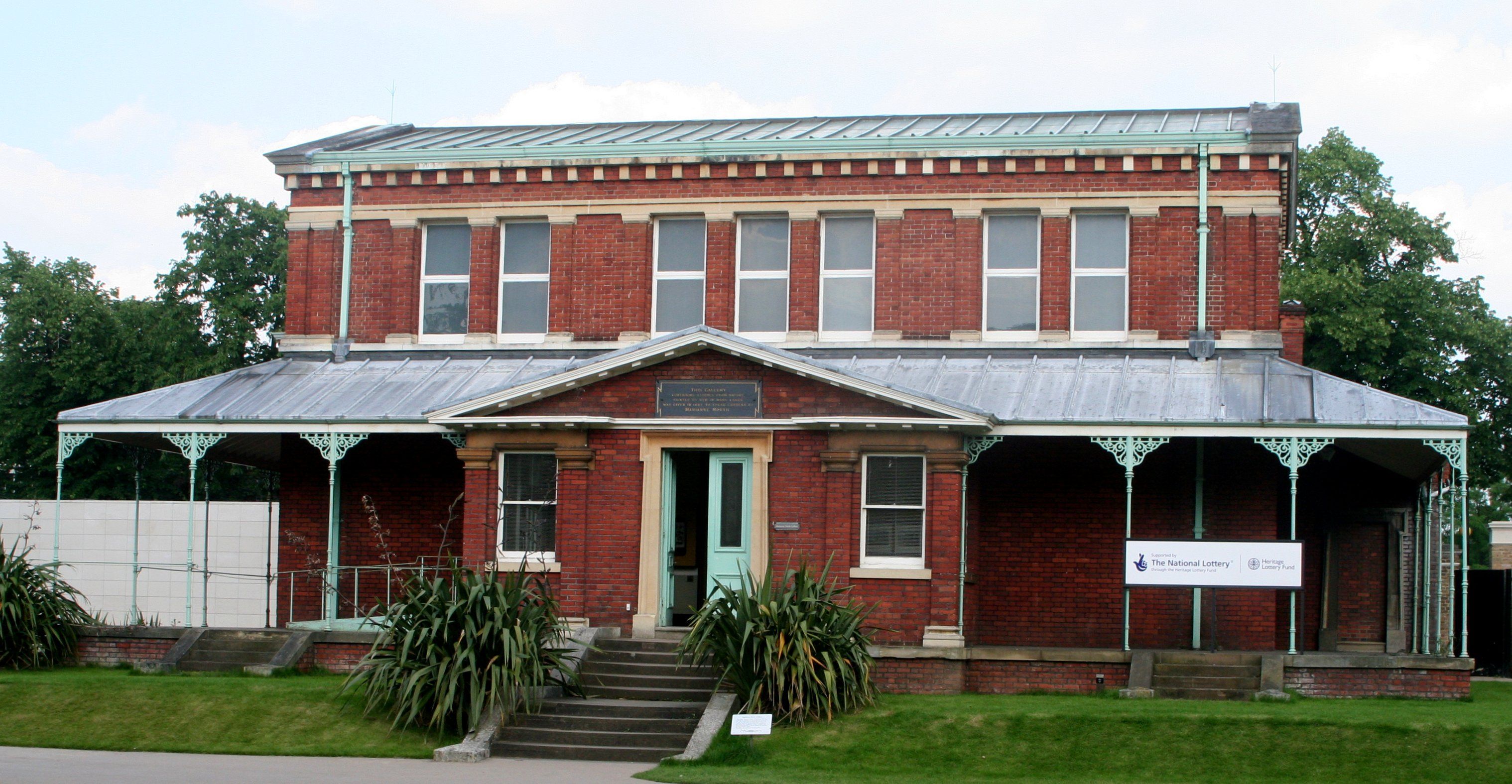 A red-brick gallery with a verandah and central entrance steps.