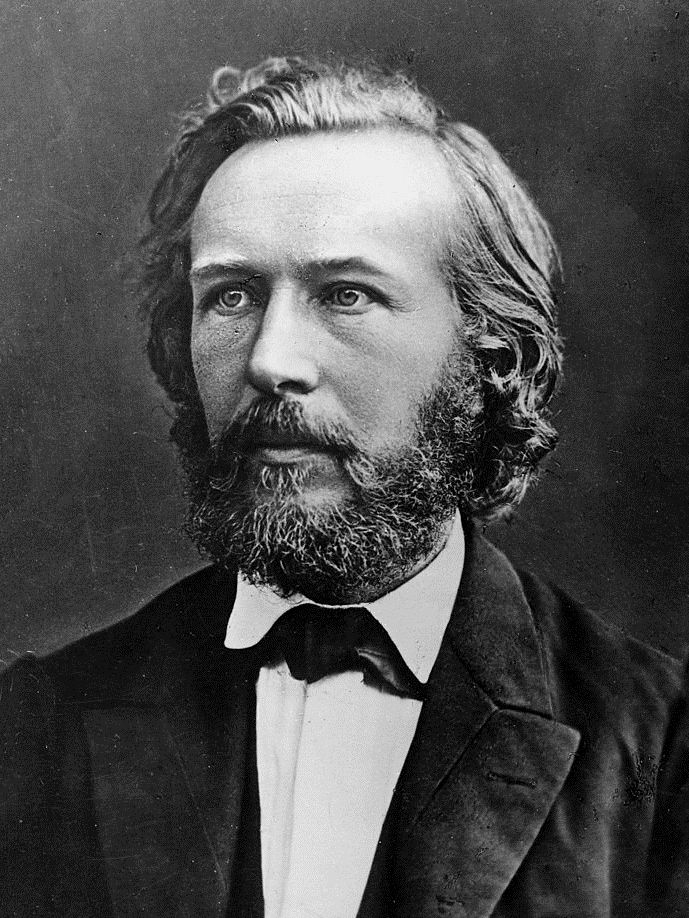A young bearded Ernst Haeckel wearing a dark coat, waistcoat and bow tie