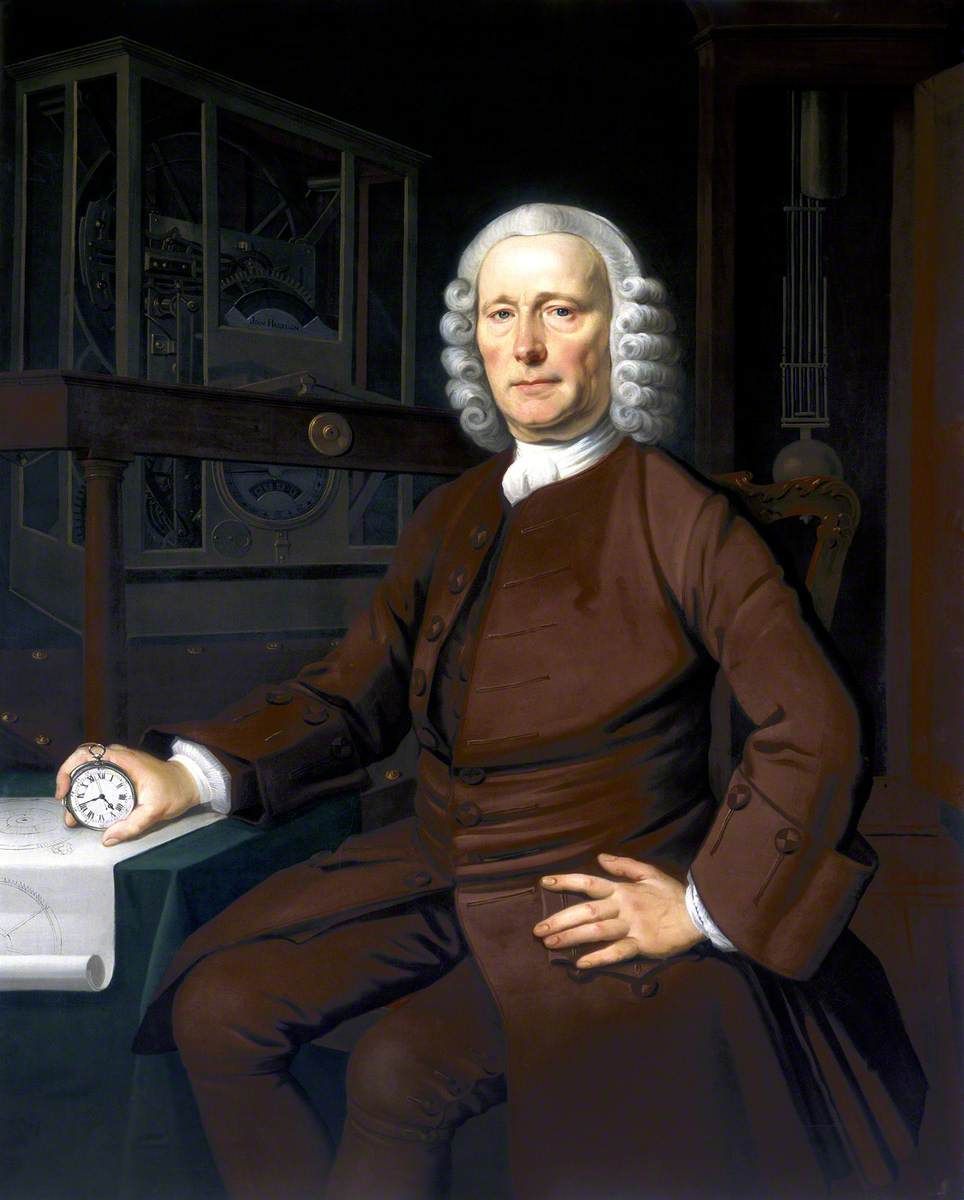 John Harrison seated with a small watch in his right hand, drawings on a table and a large clock behind him