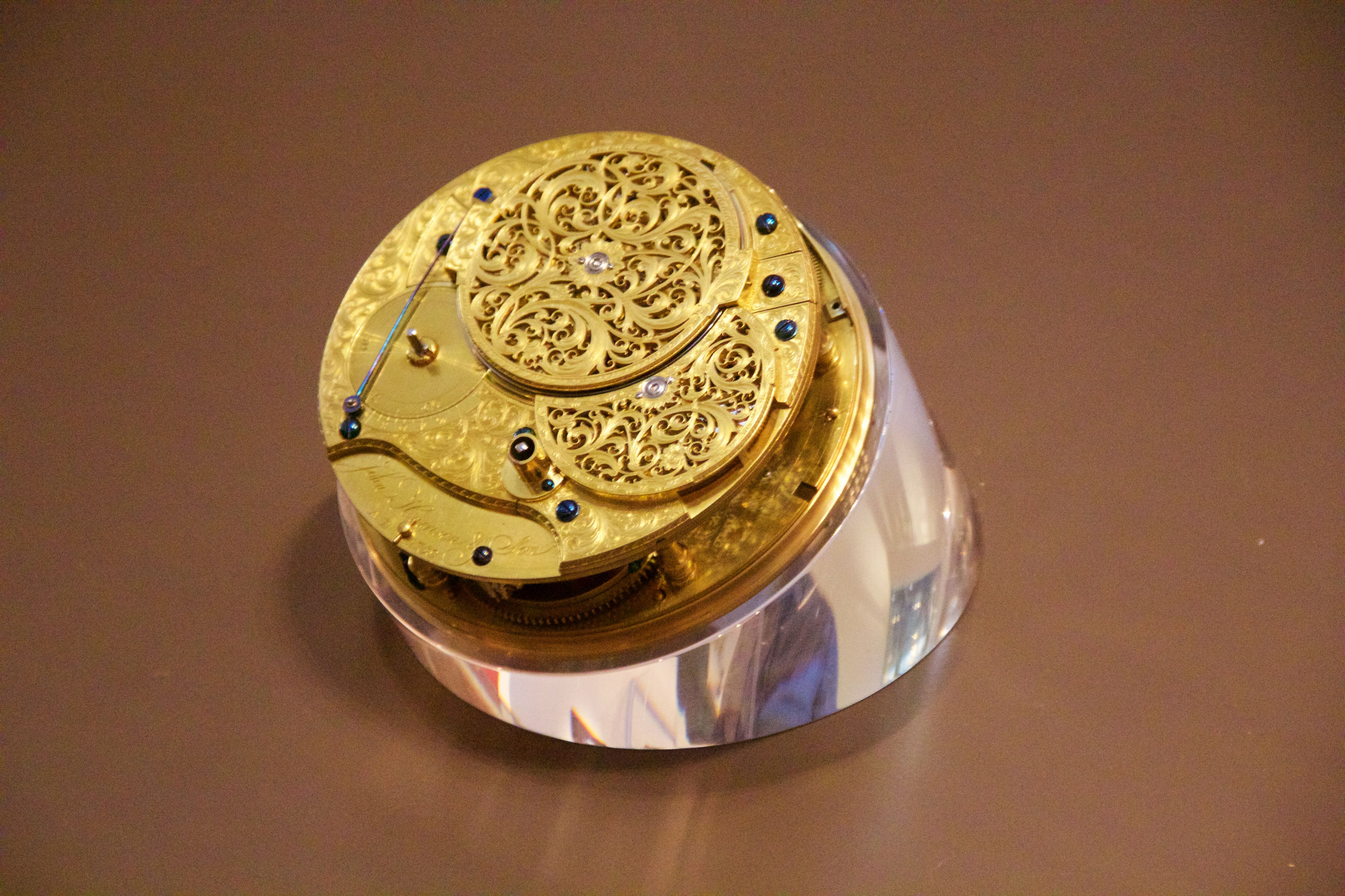 The rear of H4's gilded movement, with pierced and engraved metalwork over its mechanism