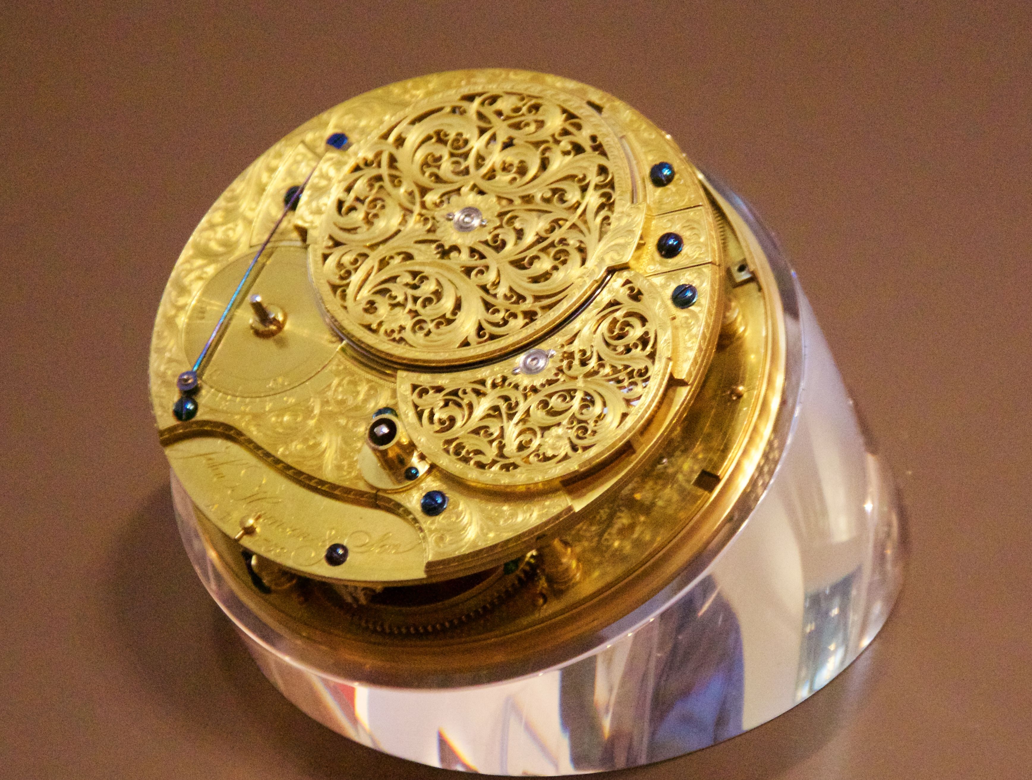 The rear of H4's gilded movement, with pierced and engraved metalwork over its mechanism