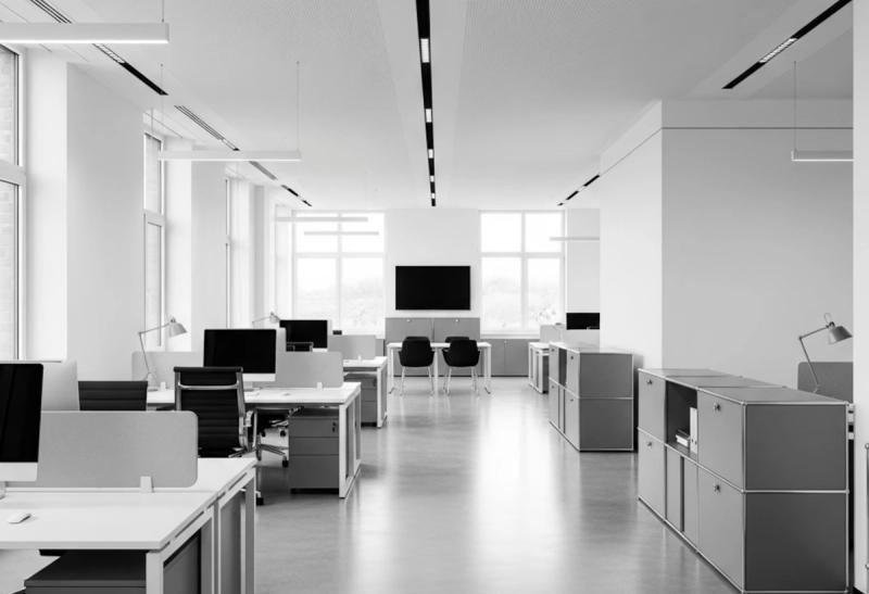 Modern commercial office workspace with desks and natural light