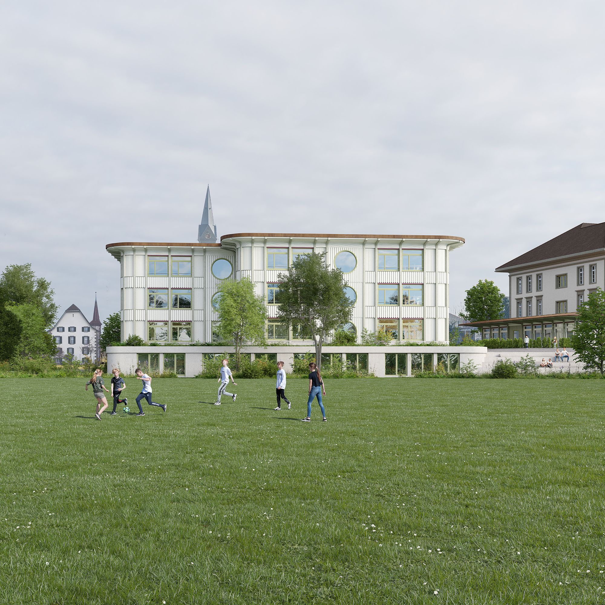 Schulhaus Paul Klee Münchenbuchsee Sportplatz mit Sicht zum Neubau