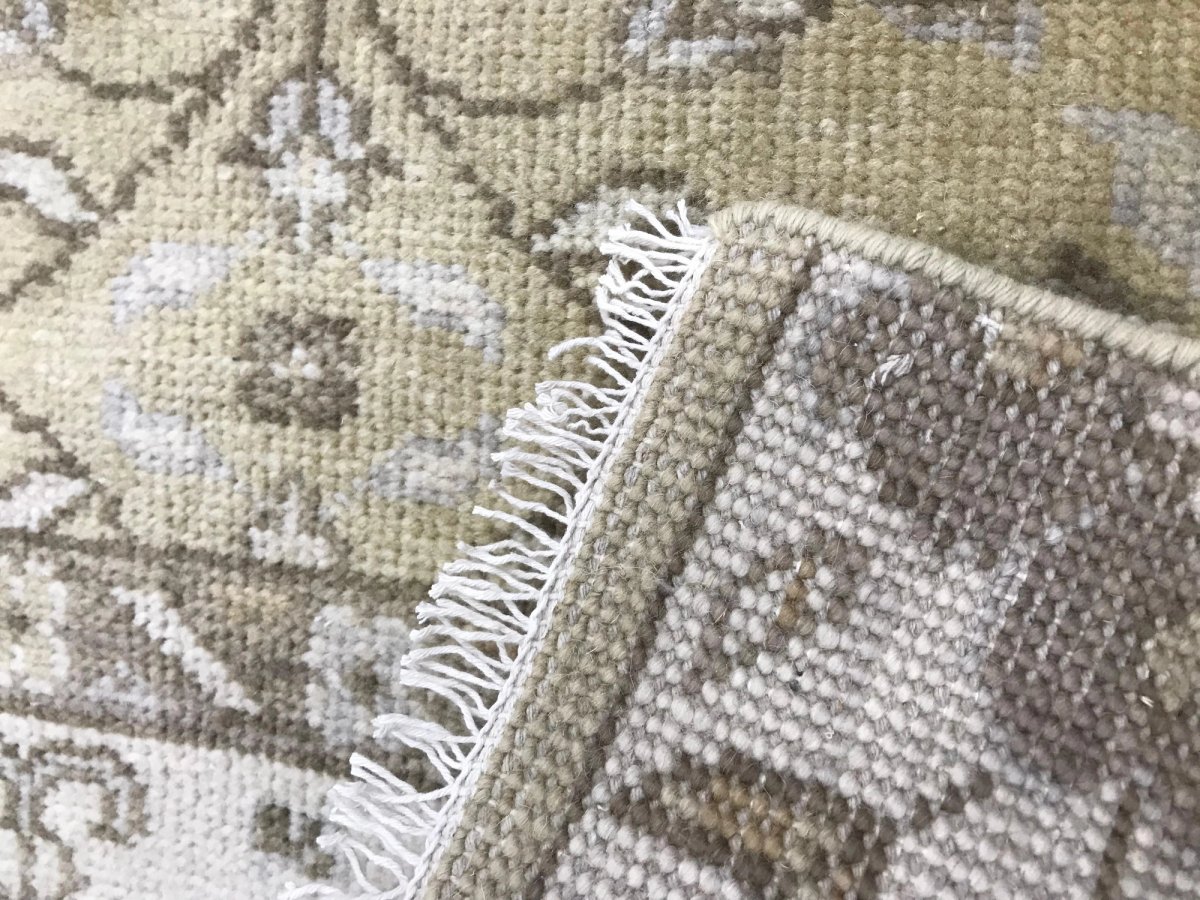 Close-up of hand knotted wool rug pile showing natural fiber texture and color depth