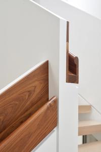 Solid walnut is used for all wear surfaces on the stair railings