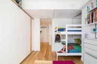 Kids' room with bunkbed tucked away to maximize use of floor space