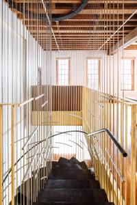 Structural brackets create a playful pattern that curves with the stairs