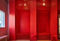 The red wall organizing Milk & Forth Ann Arbor includes spaces to eat ice cream