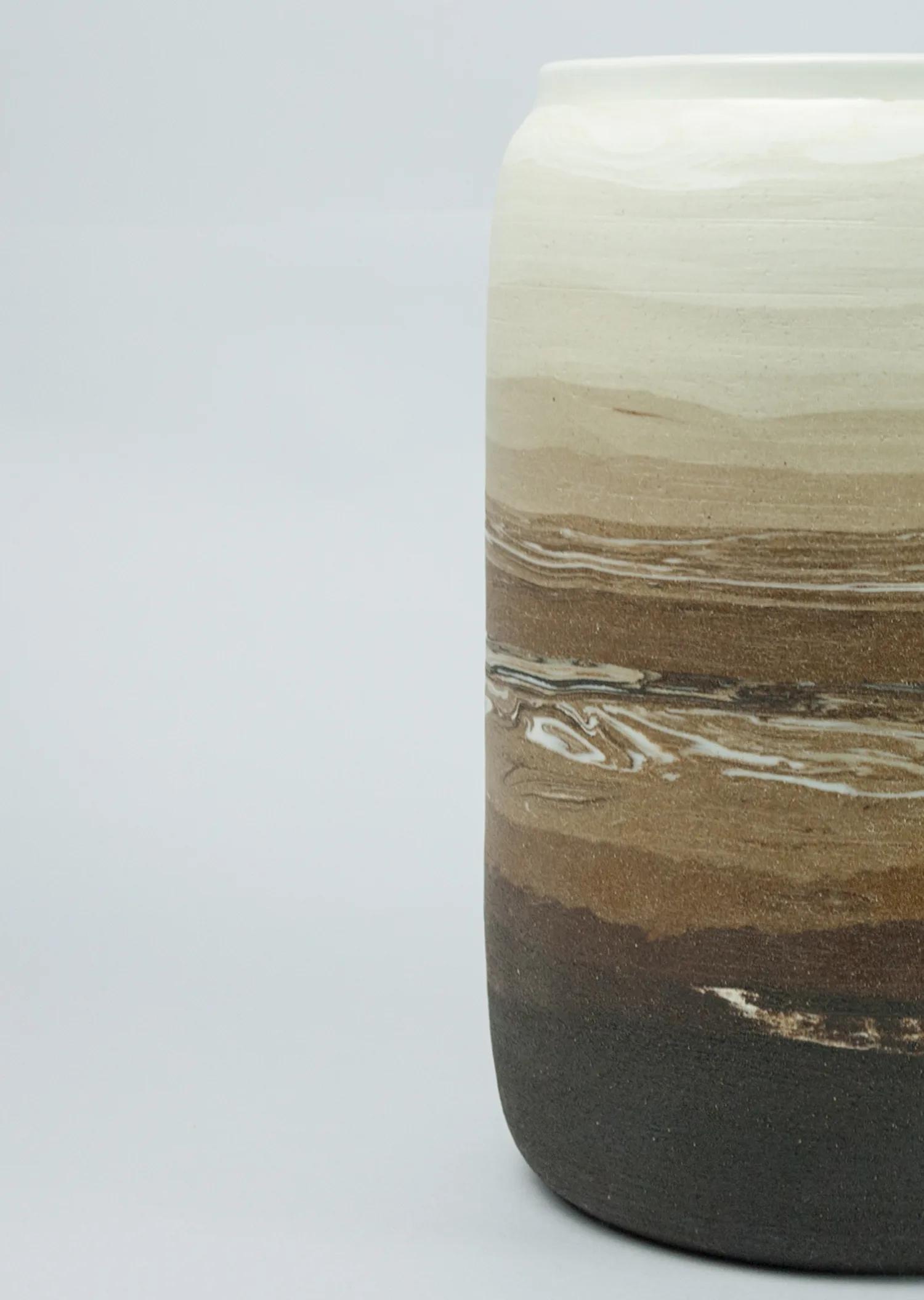 Close view of the layered, unglazed clay surfaces in the Nude collection