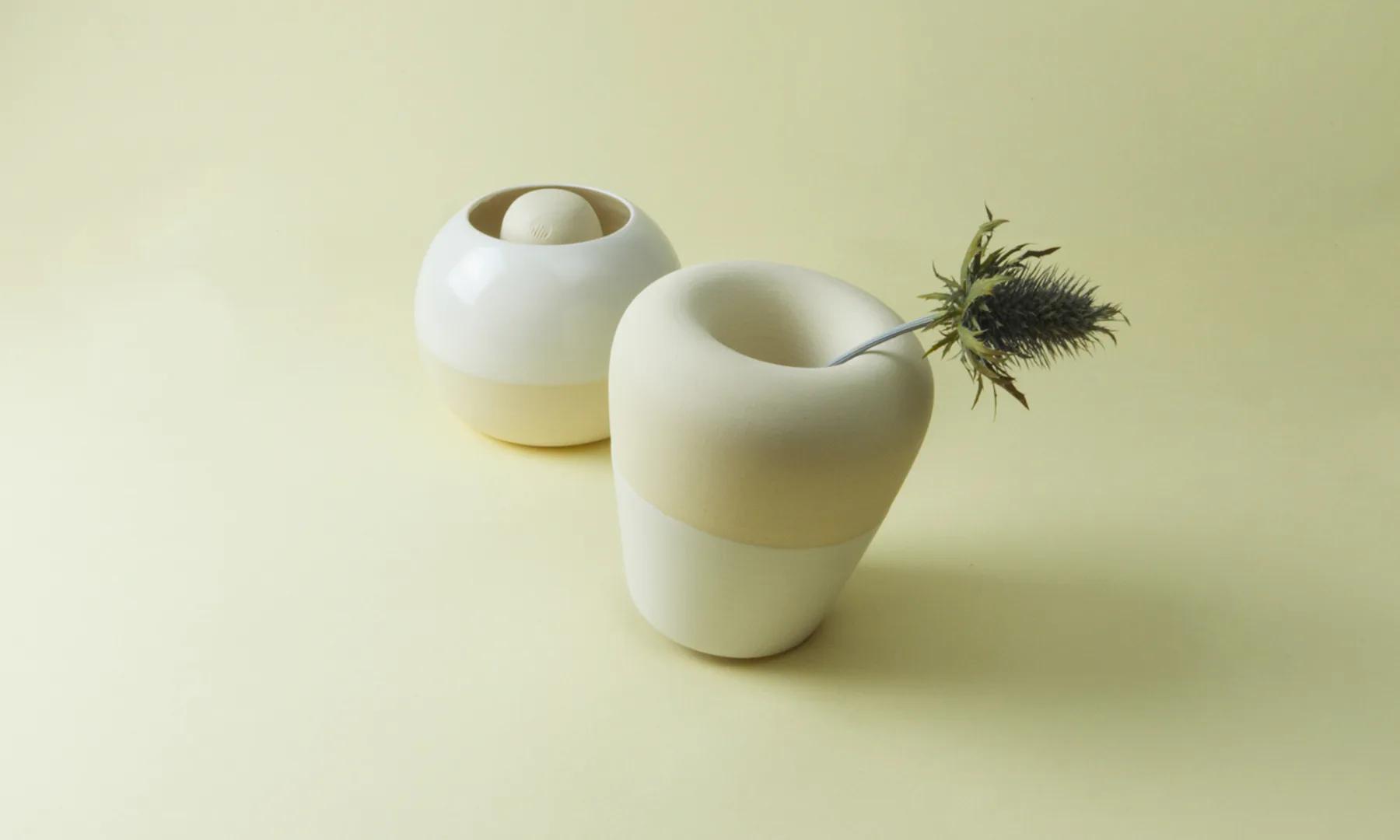Two white conical Restless vessels positioned on alternate sides