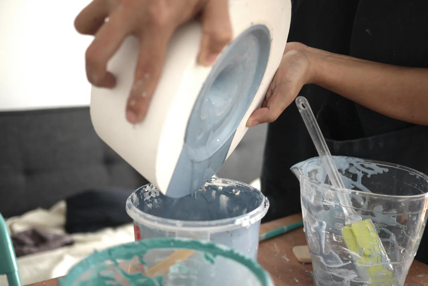 A maker refining the revolving base of a Pivot form