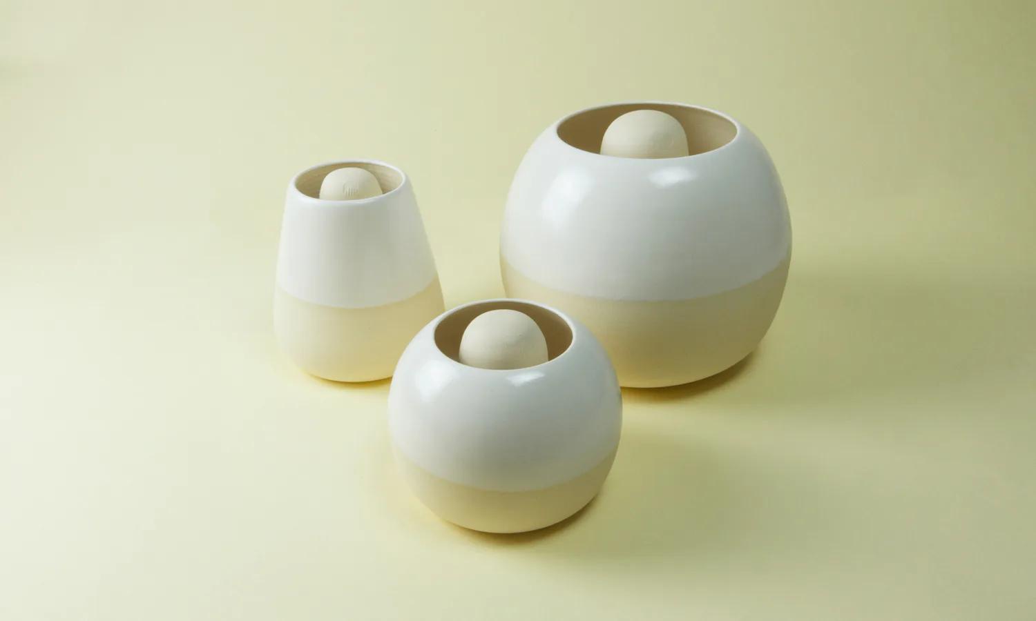 Three white Restless vessels in different orientations
