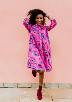 Woman wearing Pink ZURI shirt dress made by SOKO Kenya Clothing Factory