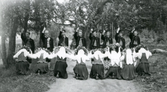 Ein sirkel av ungdommar frå BUL Nidaros i bunad som dansar