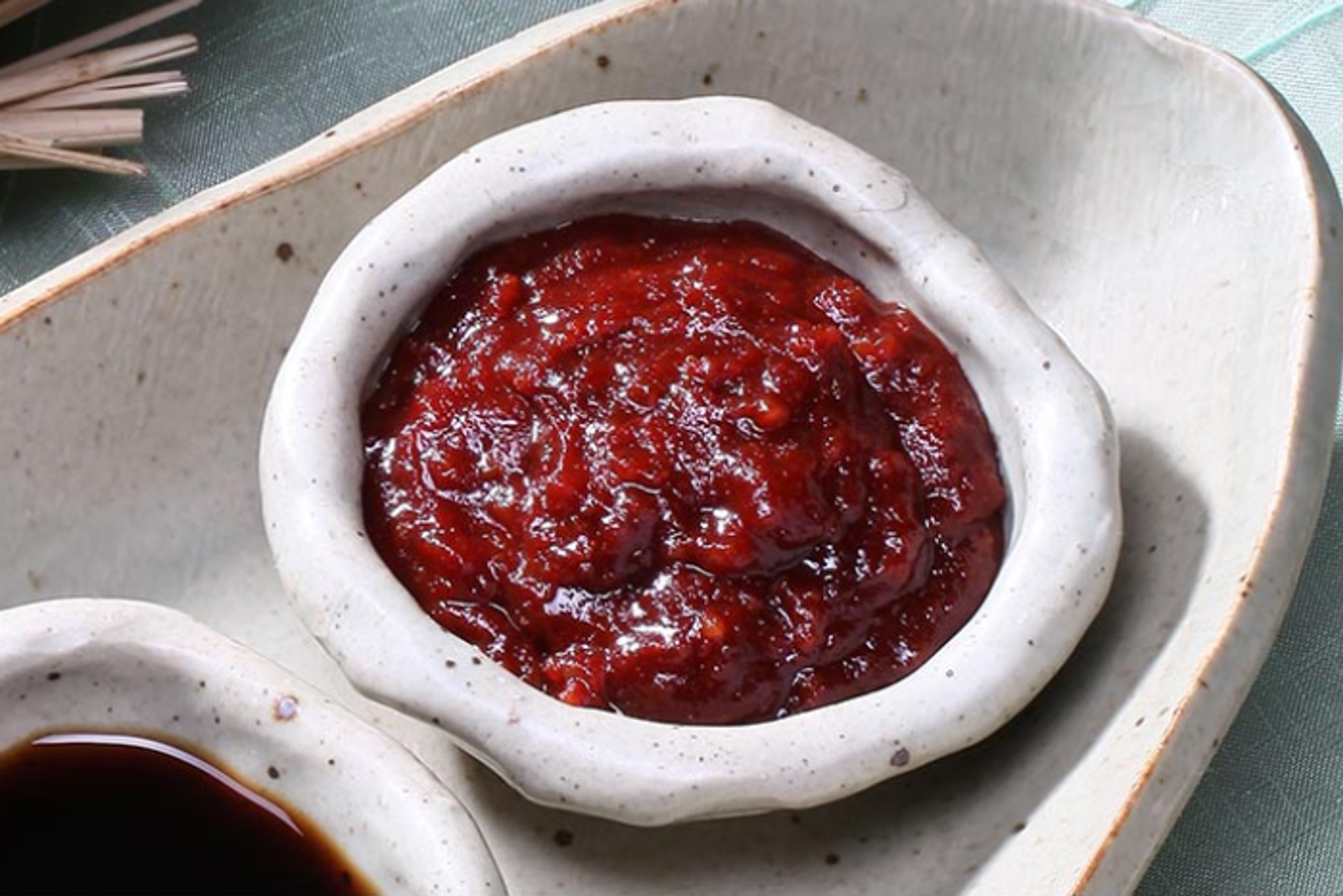 Eine Schüssel Suppe mit einem Löffel Gochujang.