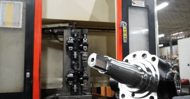 A finished, precision-machined component resting on a workbench