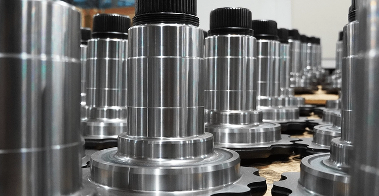 Rows of identical precision-machined parts organized on a pallet