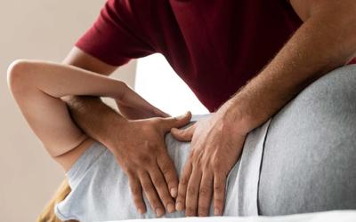 Séance de thérapie manuelle : praticien effectuant une manipulation dorsale pour soulager les tensions et améliorer la mobilité.