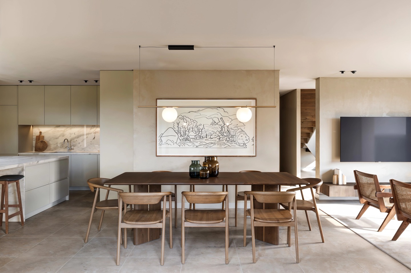 Kitchen and dining room with a timber table and cane chairs, in a house in Hossegor.