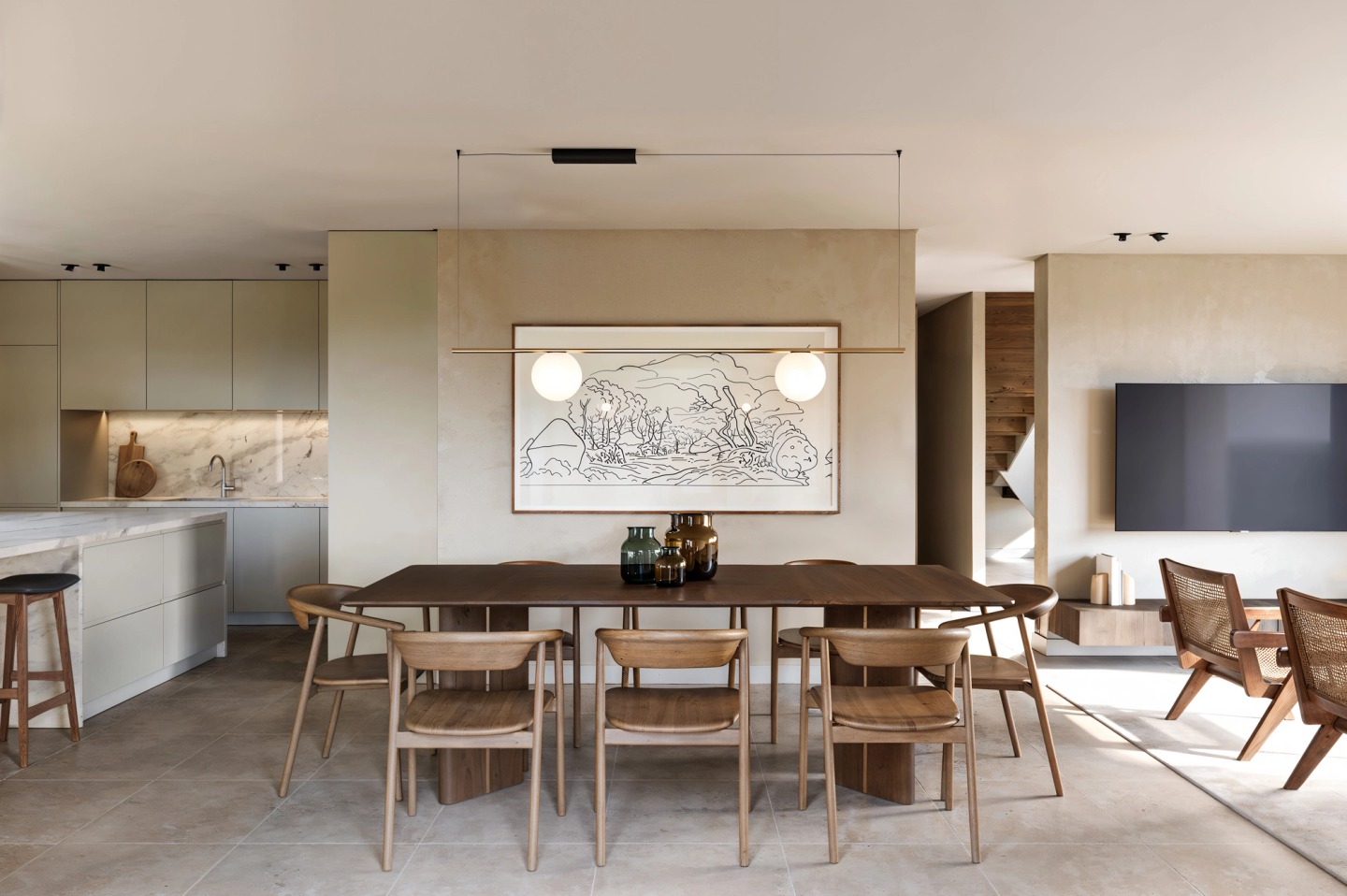 Kitchen and dining room with a timber table and cane chairs, in a house in Hossegor.
