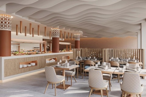 Hotel restaurant with a wave-shaped ceiling, buffet and laid tables.