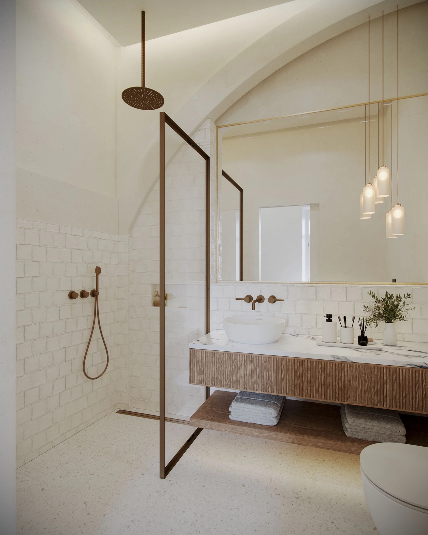 Bathroom with a brass shower, white tiles and a fluted timber vanity.