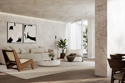 Living room with a light sofa, a cane lounge chair and black-and-white abstract artworks.