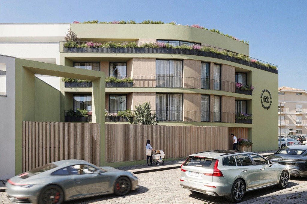 Green façade of 62 The Flat Gardens in Espinho, with flowering balconies, a roof garden and cars on the street.