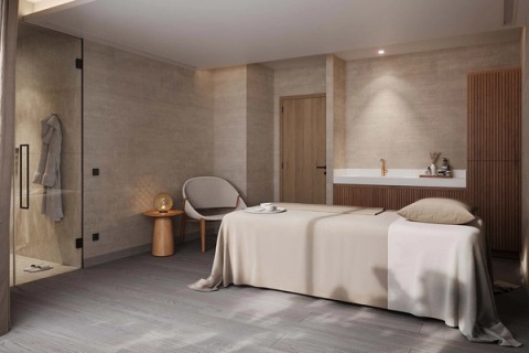 Spa treatment room with a massage table, shower and soft light.