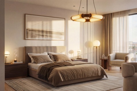 Bedroom with an upholstered headboard, pendant lamp and warm evening light.