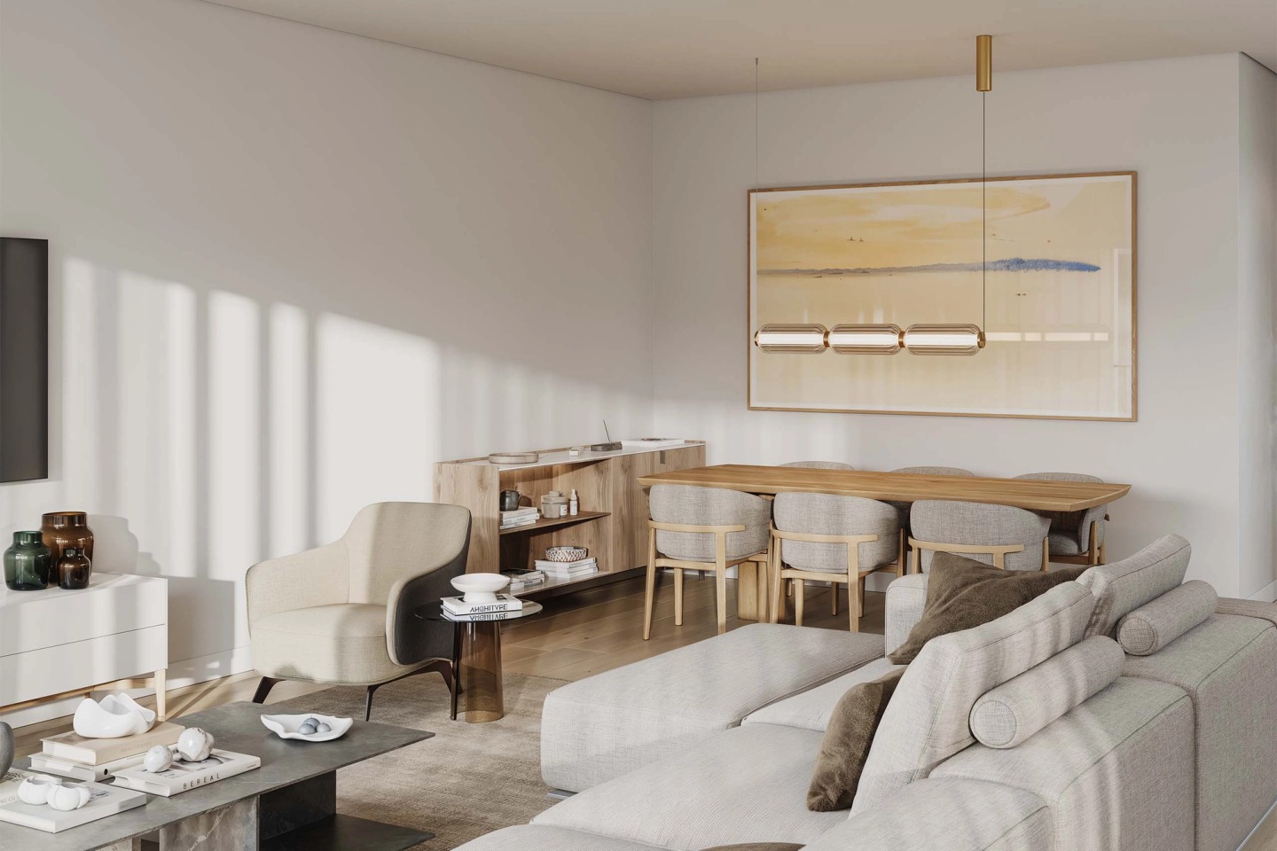 Living room with a light sofa, timber dining table and brass pendant light, in an Oásis apartment.
