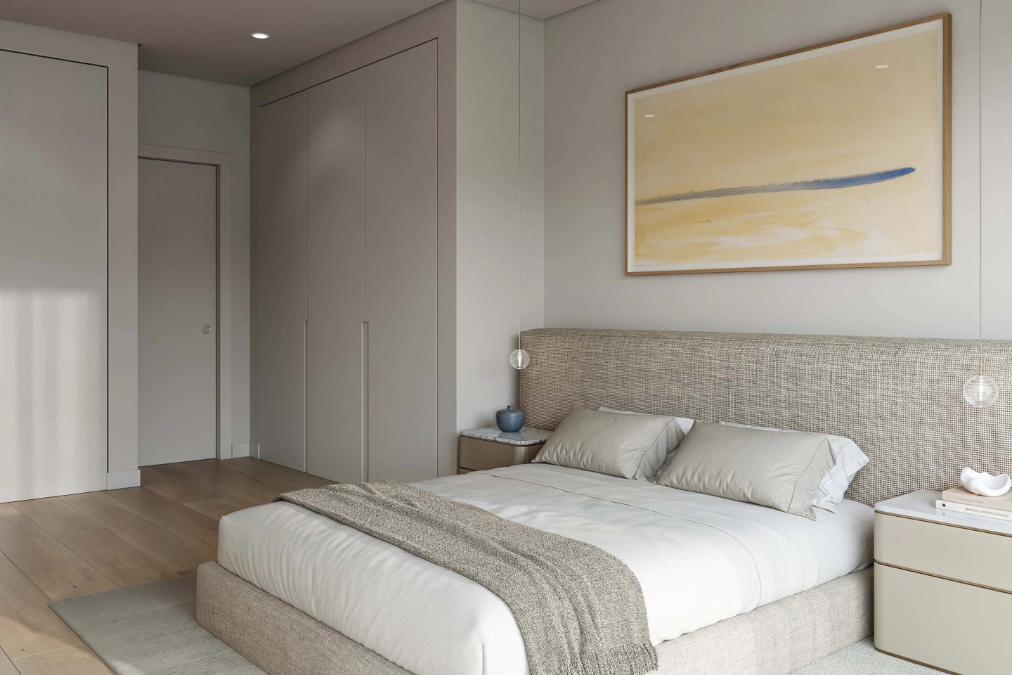 Double bedroom in neutral tones with a fabric headboard and an abstract artwork.
