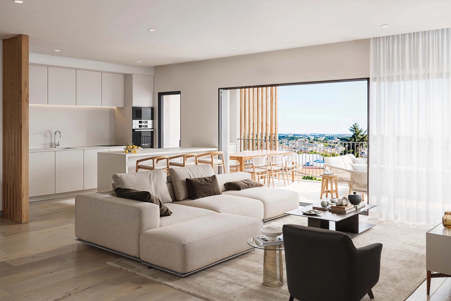 Open-plan living room and kitchen with an L-shaped sofa and a balcony overlooking Boliqueime.