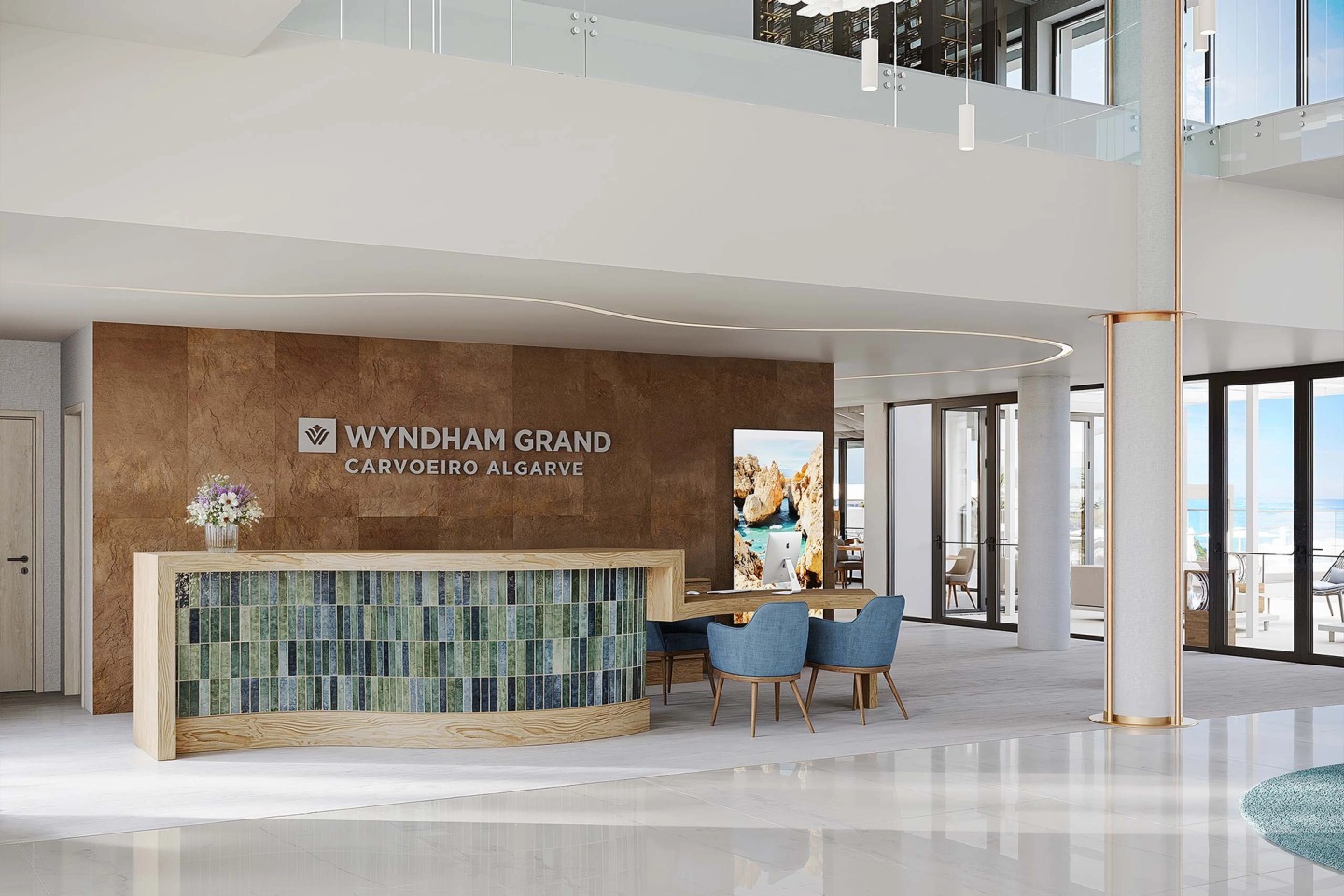 Reception of the Wyndham Grand Carvoeiro Algarve with a green-tiled desk and a stone wall.