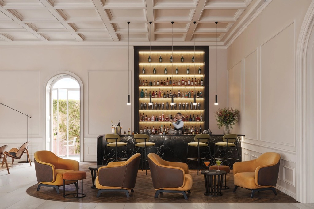 Bar at Palacete Mateus Silveira with a lit bottle wall, mustard armchairs and a coffered ceiling.