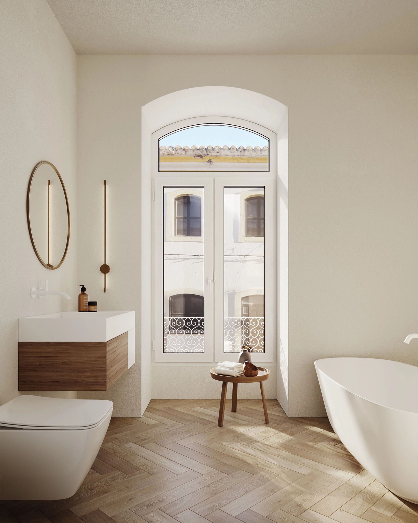 Bathroom with a freestanding bath, an oval mirror and an arched glazed door.