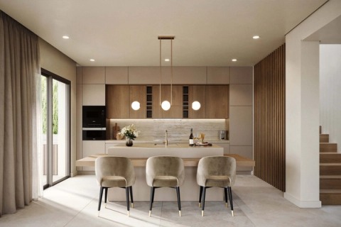 Kitchen with an island, upholstered stools and pendant globe lamps, in a Pearl Villas house.