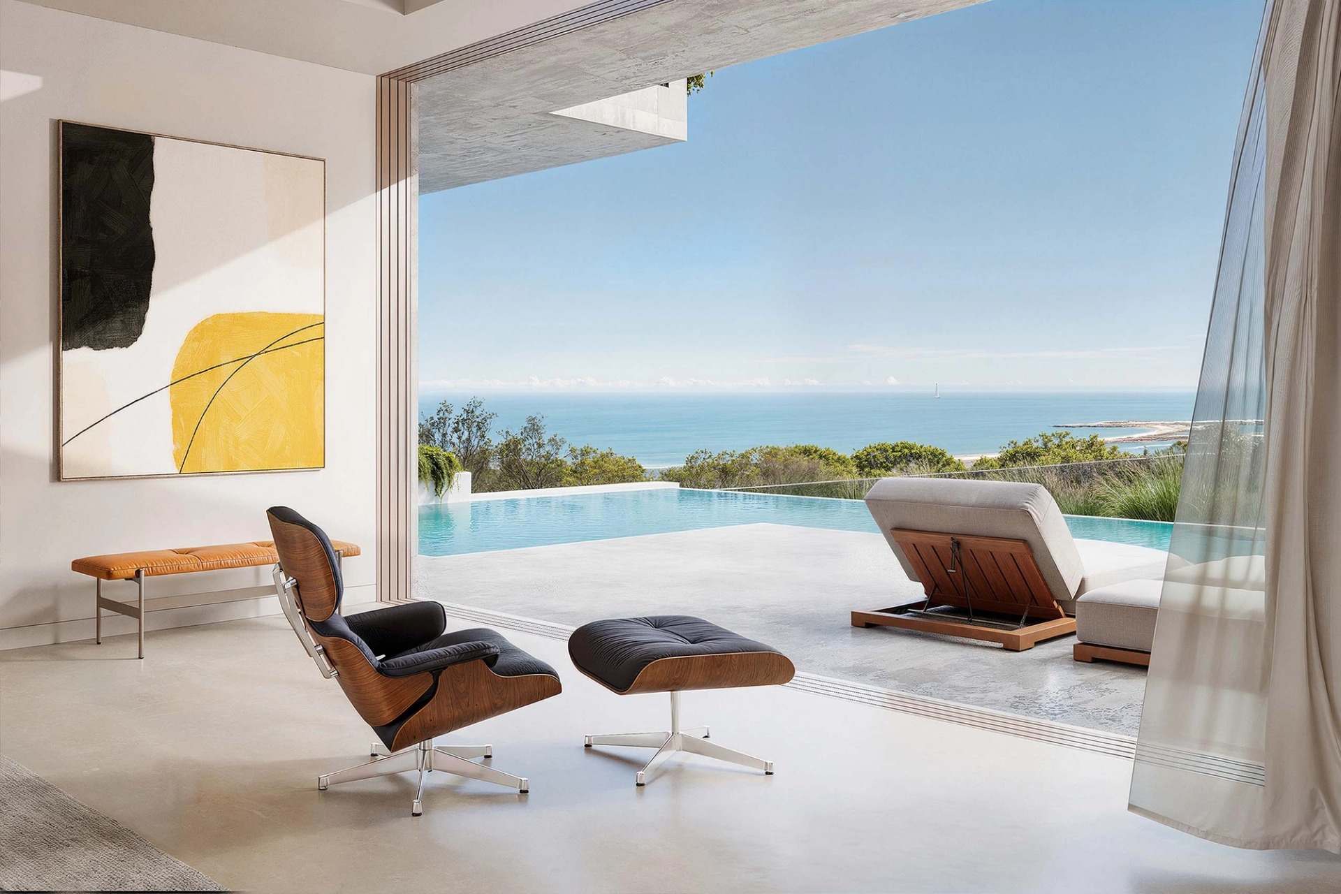 Living room opening onto the Villa Artem infinity pool, with a leather lounge chair and the Lagos sea beyond.