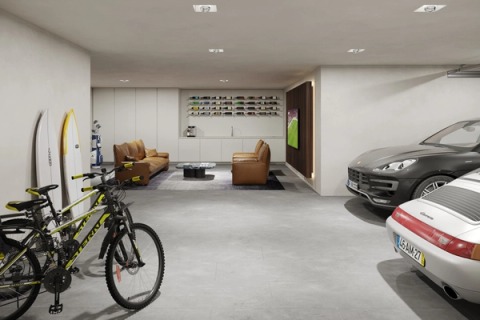 Garage with cars, bicycles, surfboards and a lounge area with leather sofas.