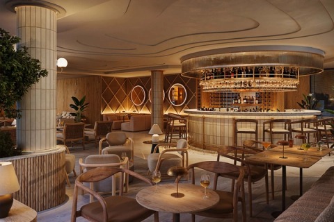 Hotel bar with a circular counter, suspended bottle rack and warm light, at the Wyndham Grand Carvoeiro.